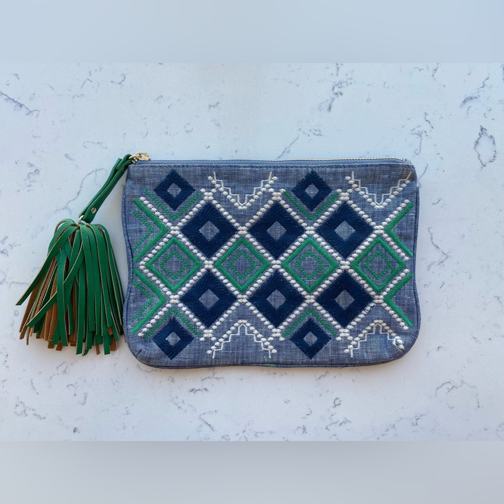 Blue and green clutch with embroidered geometric pattern and tassel